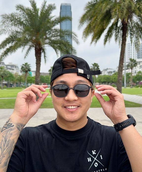 Man wearing No Se sunglasses outdoors by palm trees