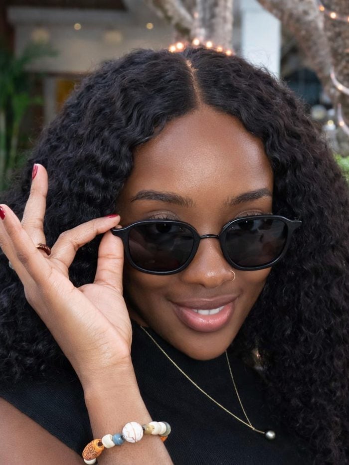 Woman wearing No Se sunglasses making a peace sign